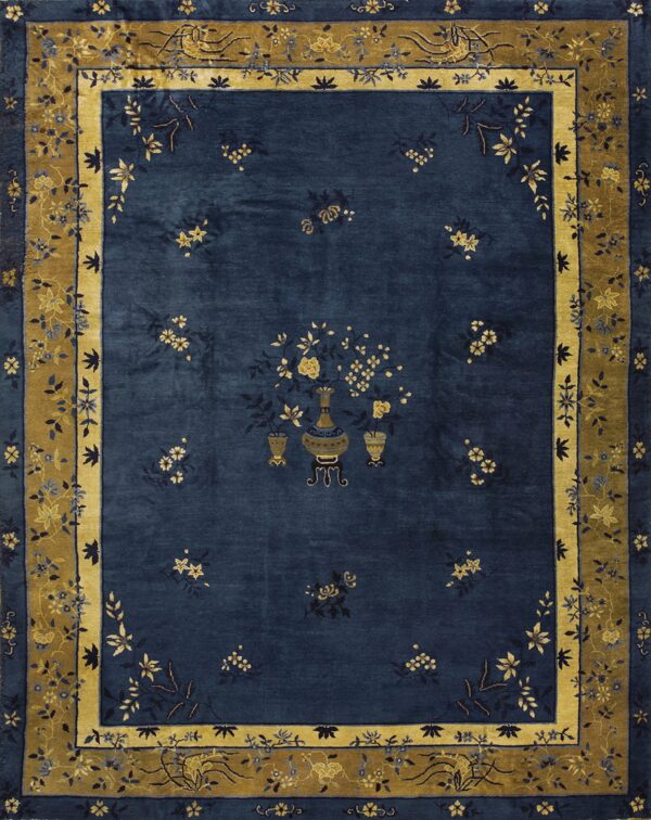 Navy blue rug with a central vase motif and gold floral sprays, framed by an elaborate gold border.