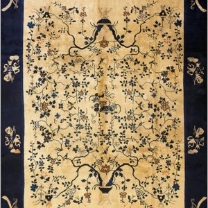 Navy and gold rug with a detailed central floral vine design and symbolic corner motifs in the border.