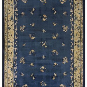 Navy blue rug with a sparse floral pattern and wide contrasting cream botanical border.