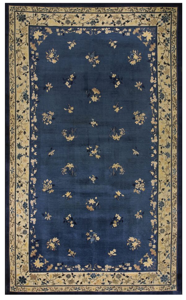 Navy blue rug with a sparse floral pattern and wide contrasting cream botanical border.