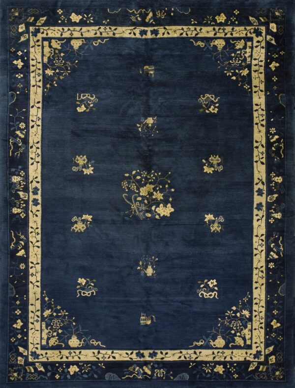 Low pile dark blue rug featuring contrast pale yellow blossoms and an ornate layered border design.