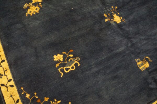 Stylized gold floral patterns scattered across a plush dark blue rug surface.