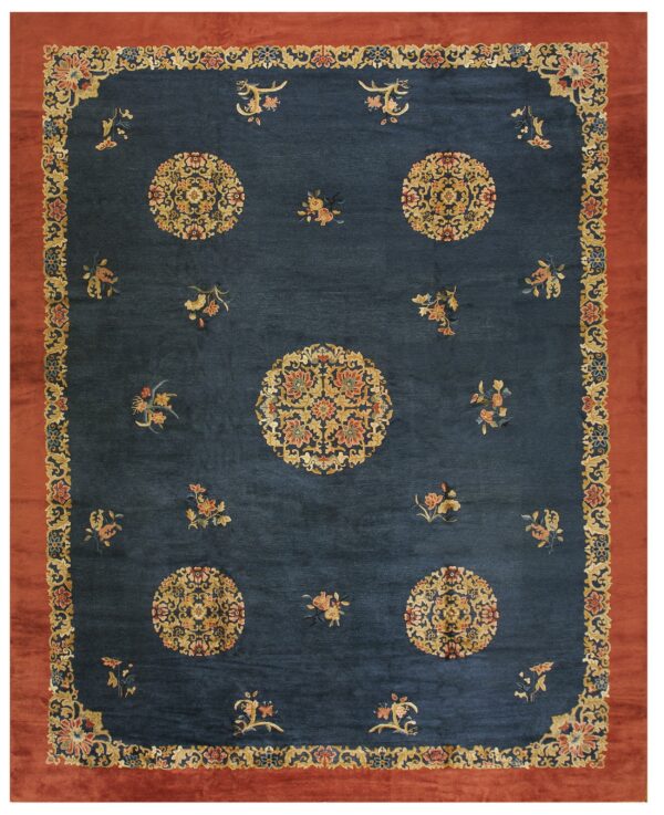 Ornate indigo rug featuring gold floral medallions and a broad solid rust red outer border.
