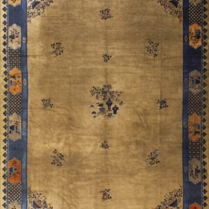 Gold tan rug with scattered blue floral motifs and an elaborate blue and orange decorative border.