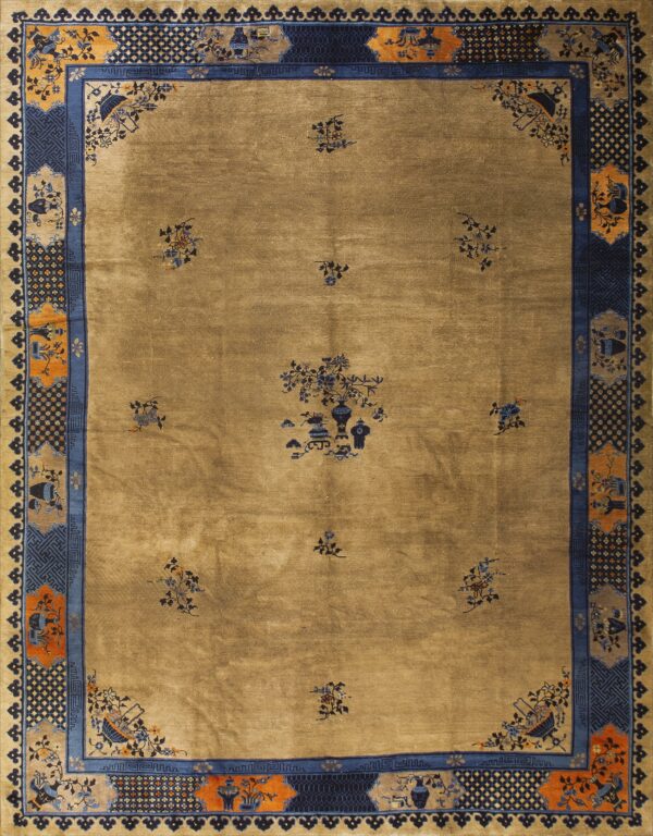 Gold tan rug with scattered blue floral motifs and an elaborate blue and orange decorative border.