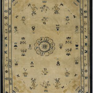 Beige traditional rug featuring scattered blue and gold auspicious symbols, a central medallion, and a dark blue border.