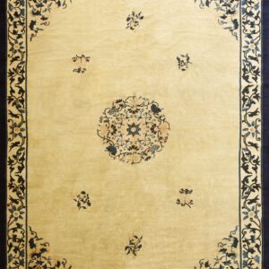 Pale yellow rug featuring a wide navy border with blue floral scrollwork and a matching central medallion.