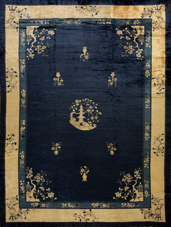 Dark blue velvety rug with gold motifs featuring a central pagoda and wide beige floral border.