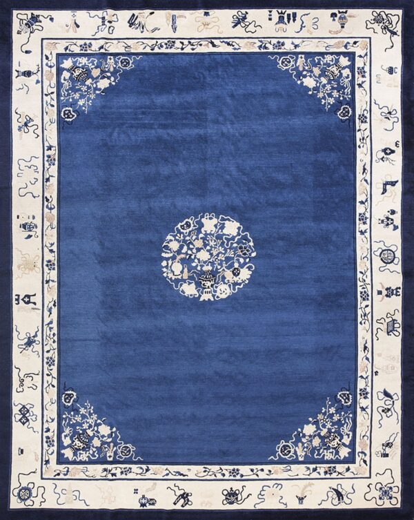 A rich blue rug with cream borders, featuring traditional floral corner sprays and symbols.