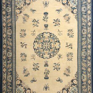 Beige rug with navy blue and teal floral sprays, a central medallion, and multiple detailed borders.