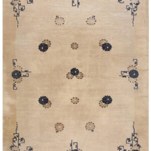 Beige rug with dark blue and tan stylized floral medallions and geometric corner designs.