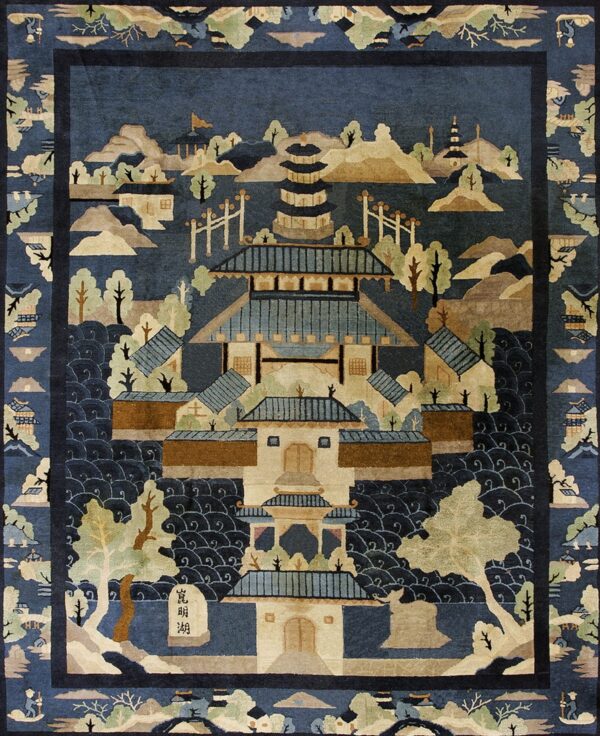 Deep blue pictorial rug depicting a large pagoda surrounded by beige and green landscape elements.