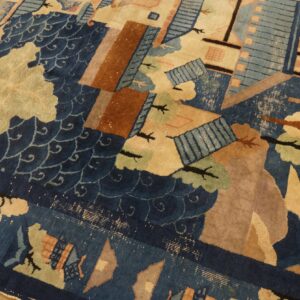 Blue and beige rug displaying a stylized landscape pattern with brown geometric shapes over hardwood.