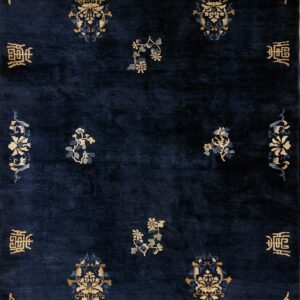Deep blue high-pile rug with scattered golden and pale blue traditional floral and script designs.