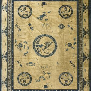 Gold and navy rug featuring traditional motifs, medallions, and a repeating fretwork border pattern.