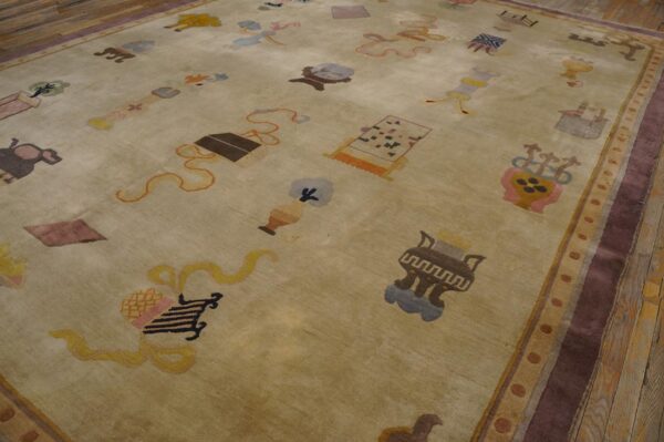 Light green-beige rug with scattered multicolored symbols and a wide maroon border on rustic wood flooring.