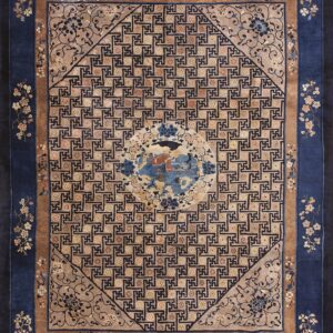 Blue and tan rug featuring a central medallion, geometric key pattern, and intricate floral borders.
