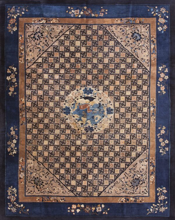 Blue and tan rug featuring a central medallion, geometric key pattern, and intricate floral borders.