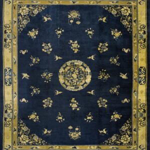 Navy blue rug with a gold border and central medallion, featuring scattered floral and bird patterns.