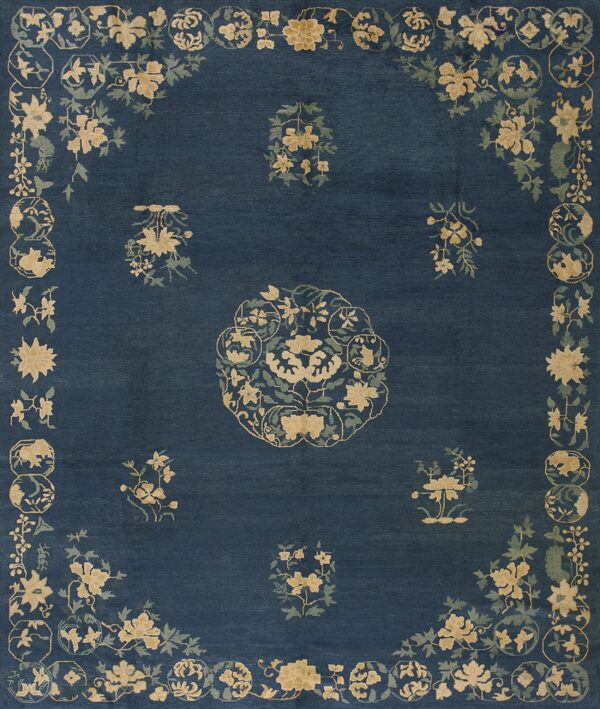 Deep blue rug featuring a central medallion and scattered tan and green floral sprays and a complex border.