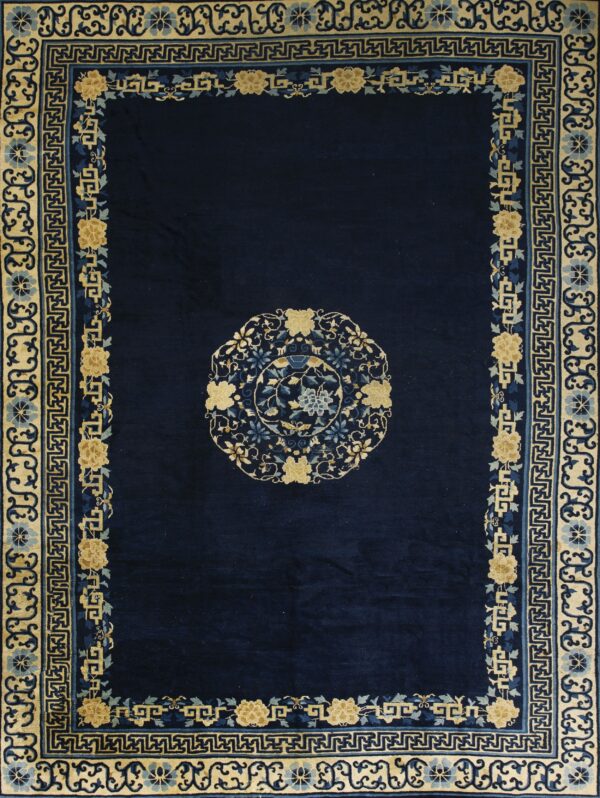 Dark blue rug with a circular floral medallion and wide multi-banded border in tan, gold, and blue.