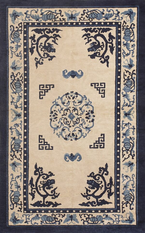 Beige and navy blue rug featuring a central medallion and complex borders with floral and butterfly patterns.