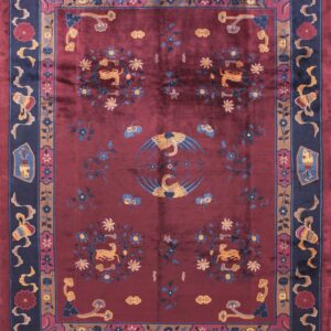 Burgundy high-pile rug featuring a central swan motif, two deer medallions, and complex navy blue borders.