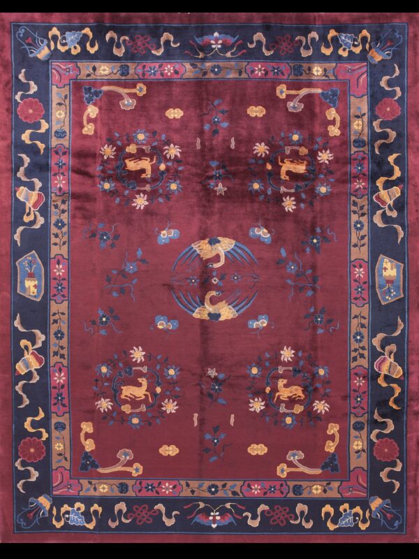 Burgundy high-pile rug featuring a central swan motif, two deer medallions, and complex navy blue borders.