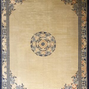 Beige rug with a central blue and coral medallion surrounded by ornamental navy and light blue borders.