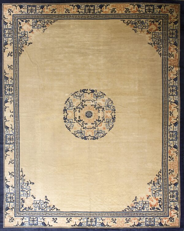 Beige rug with a central blue and coral medallion surrounded by ornamental navy and light blue borders.
