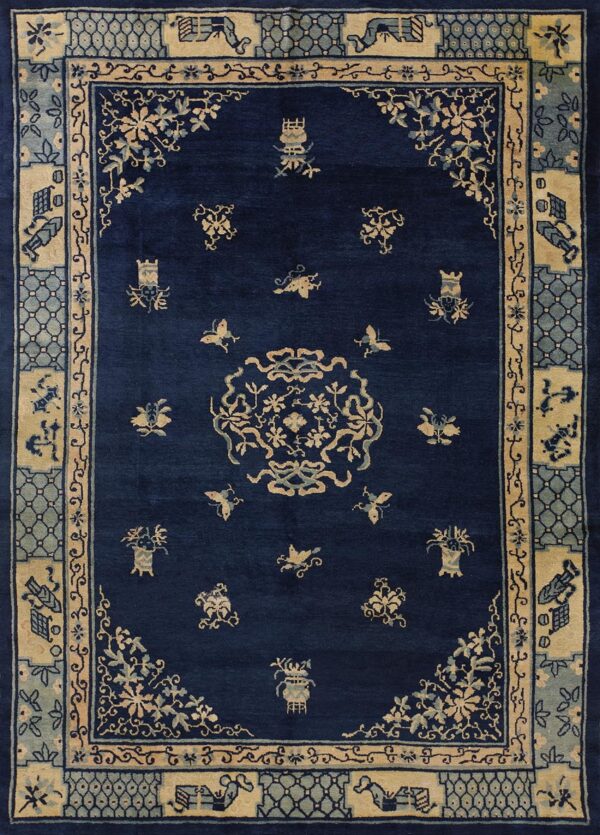 Navy rug with a central medallion, scattered symbols, and multiple borders in beige and light blue.