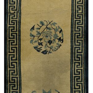 Long tan runner rug featuring scattered blue floral motifs and a Greek key dark blue border.