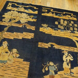 A navy blue pile rug with gold pictorial scenes rests on a highly varnished light wood floor.