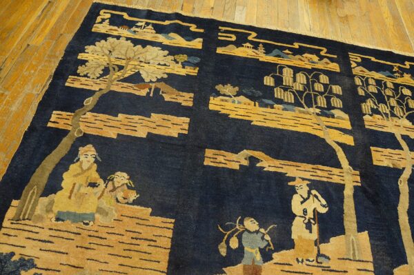 A navy blue pile rug with gold pictorial scenes rests on a highly varnished light wood floor.