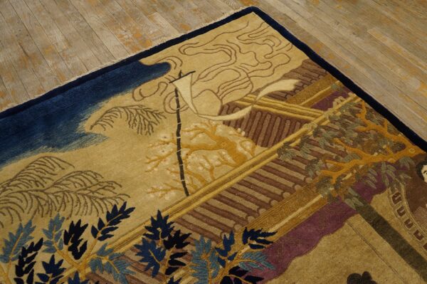 Detailed scenic rug pattern in tan, gold, navy, brown, and maroon laying on a light wood floor.