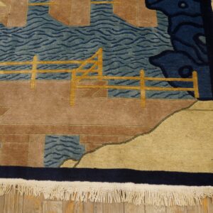 Scenic rug pattern featuring teal water, brown terrain, and golden fence details on a wooden floor.