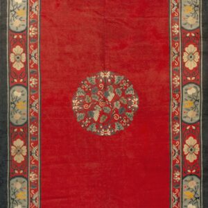 Low-pile red rug featuring a central vine medallion and wide, detailed blue and cream floral borders.