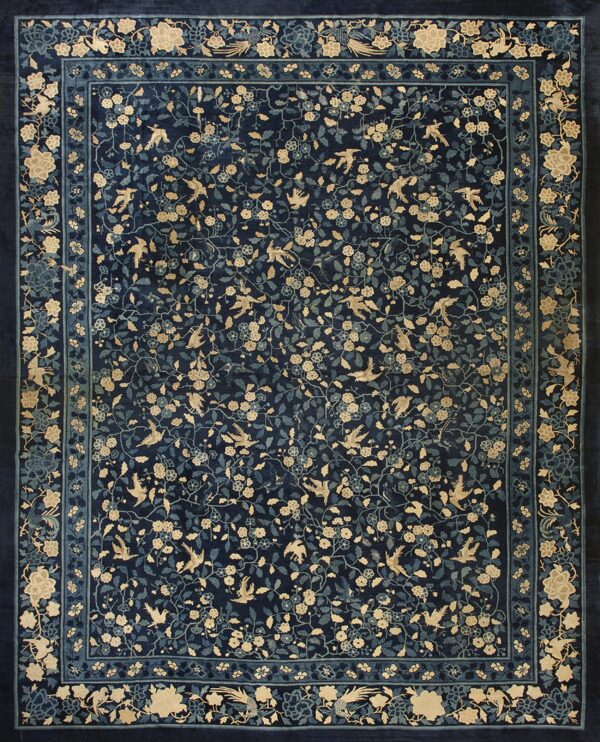 Navy blue rug featuring a dense pattern of flying tan birds, light blue vines, and detailed floral borders.