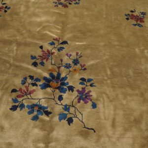 Golden-brown rug featuring large stylized floral vines in blue, red, and purple across a shiny field.