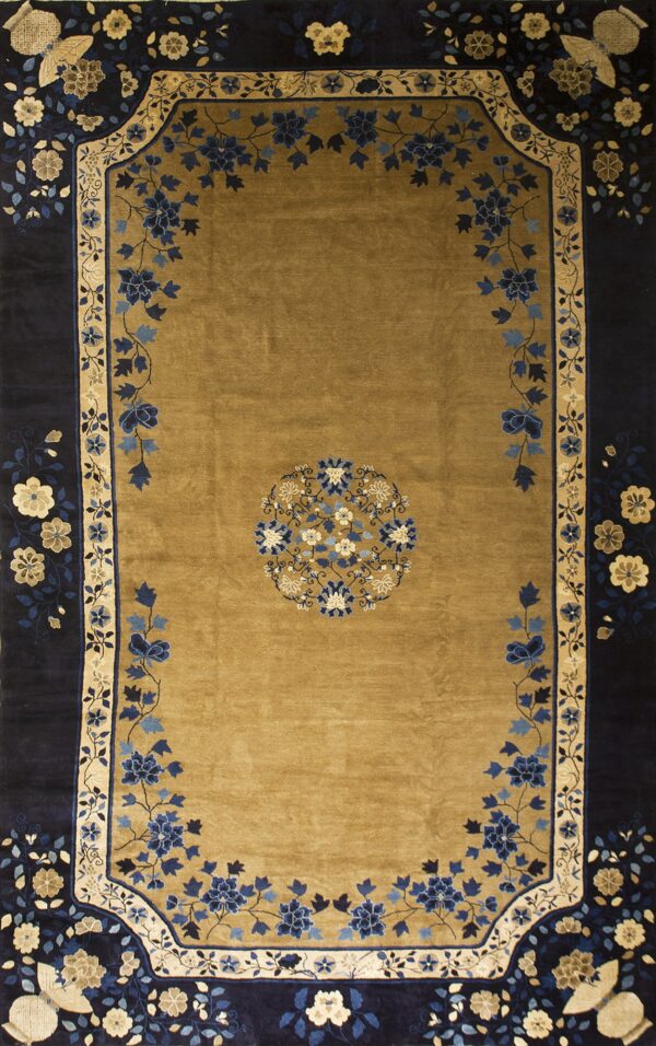 Golden brown rug with a navy border and detailed floral medallions in shades of blue and cream.