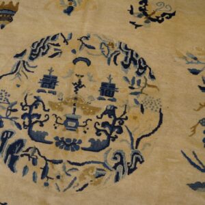 Creamy yellow rug with a complex blue and gold medallion pattern and scattered floral motifs.