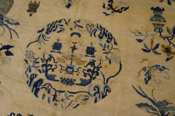 Creamy yellow rug with a complex blue and gold medallion pattern and scattered floral motifs.