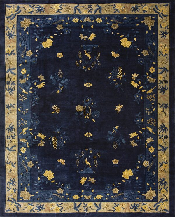 Plush navy rug with a detailed border and central field of gold and blue floral and bird patterns.