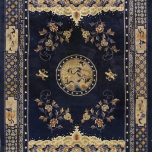 Intricate navy blue rug with layered geometric and floral borders and a central round bird motif.