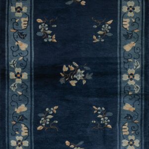 Navy blue runner with light blue floral sprigs and a detailed border in a lighter slate tone.