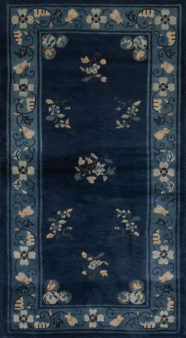 Navy blue runner with light blue floral sprigs and a detailed border in a lighter slate tone.