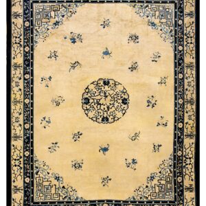 Traditional pale yellow rug with dark blue borders and scattered floral sprays around a central medallion.