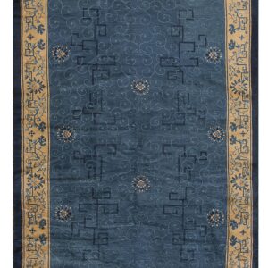 Deep blue rug with faint scrolling patterns and a wide beige border decorated with blue flowers.