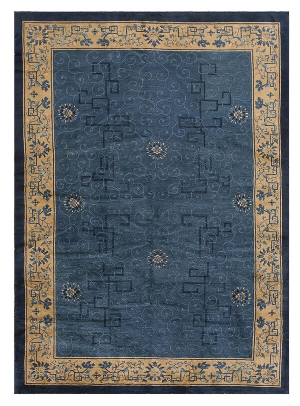Deep blue rug with faint scrolling patterns and a wide beige border decorated with blue flowers.