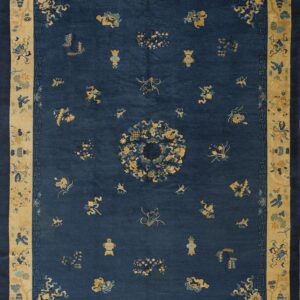 A deep blue rug featuring scattered yellow and light blue traditional motifs within a wide patterned beige border.